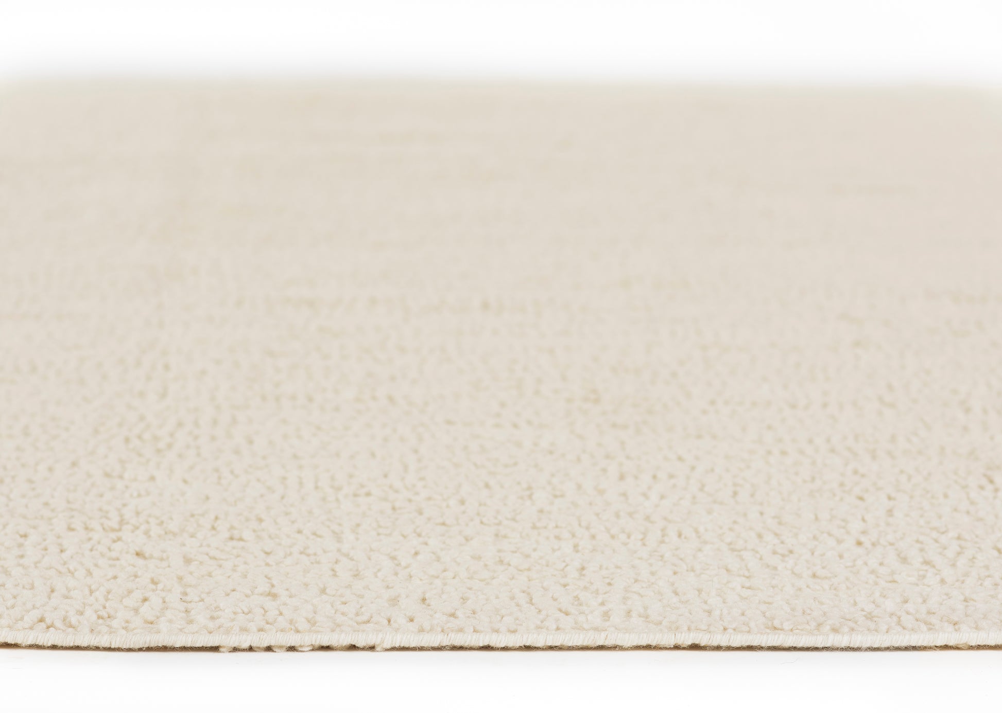 Ivory beige textured rug close-up with dense loop pile and flat edge.