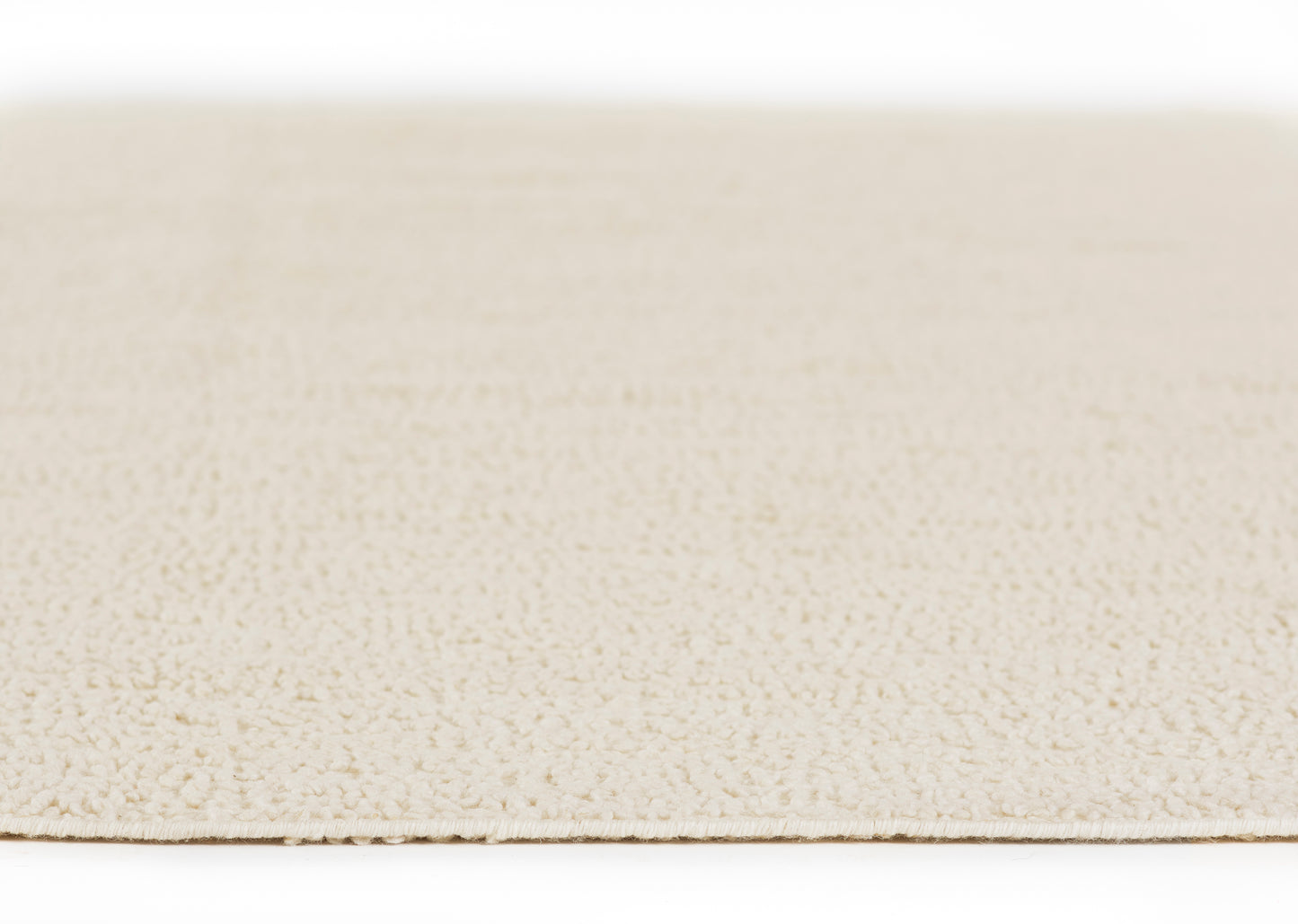 Beige pebble-textured faux leather surface, close-up with visible edge.