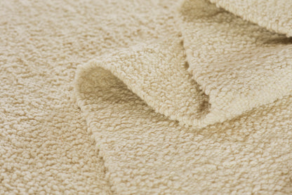 Beige rug runner; close-up of plush, looped texture with a folded edge; size 3' x 8'.