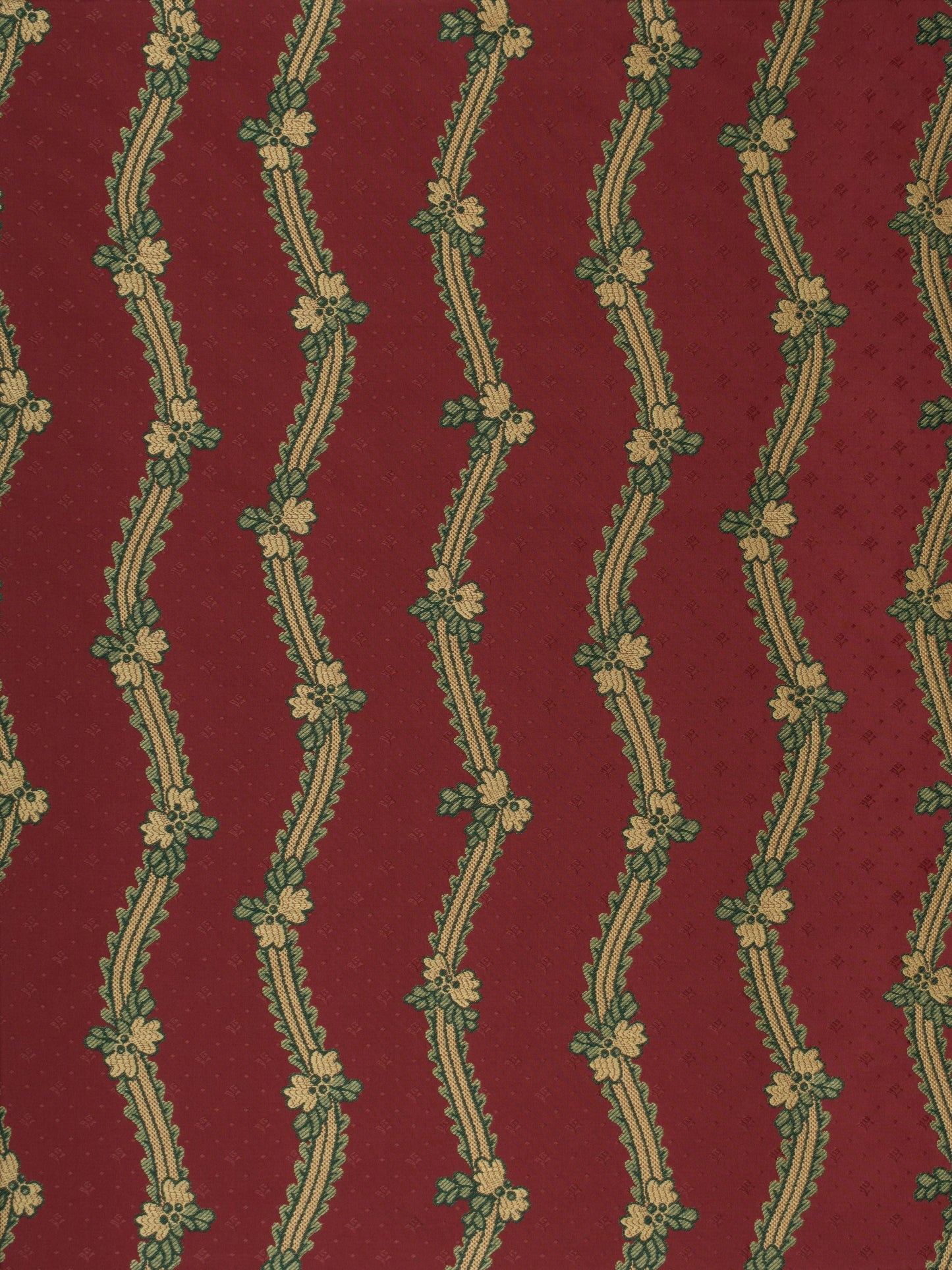 Maroon fabric with cream wavy vertical stripes entwined by green floral vines and small blossoms.