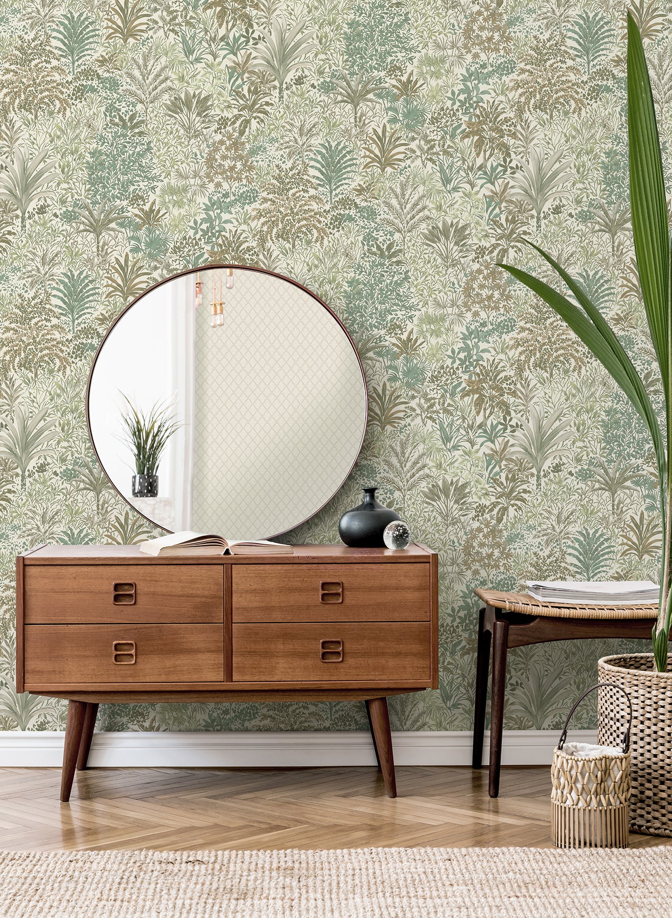 Green palm landscape wallpaper with a tropical botanical motif on the wall; potted plant, vase, books and a woven basket nearby.