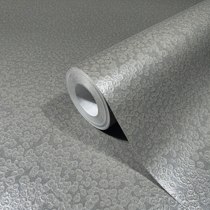 Silver metallic wallpaper roll with pebble-textured embossed surface for accent walls.