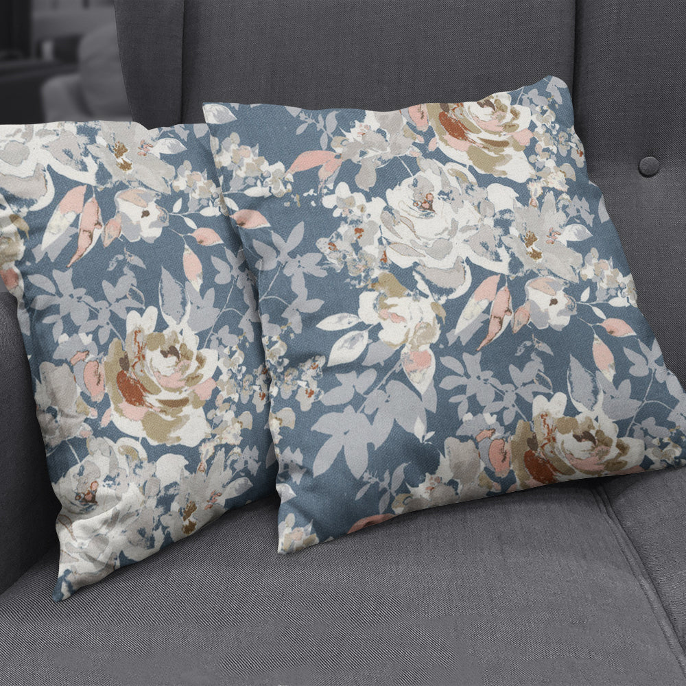 Two rectangular solid-color throw pillows in blue-gray on a gray sofa