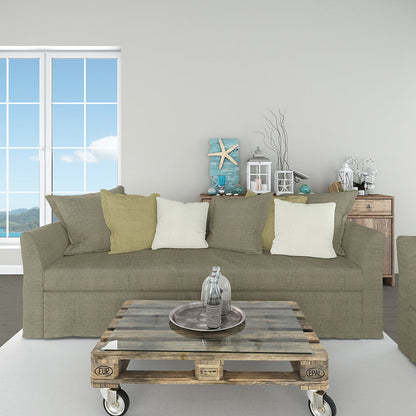 Taupe sofa with mixed olive and cream cushions, rustic pallet coffee table on casters, coastal decor by a large ocean-view window