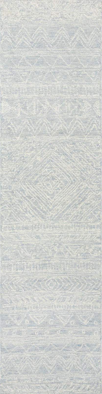 Rectangular woven rug in pale gray-blue with subtle geometric diamonds and chevrons; soft, textured decor.
