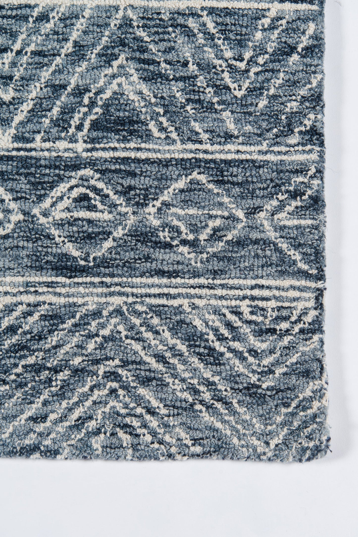 Navy blue rug with off-white geometric diamonds; plush woven texture, boho & tribal style for living room or hallway.