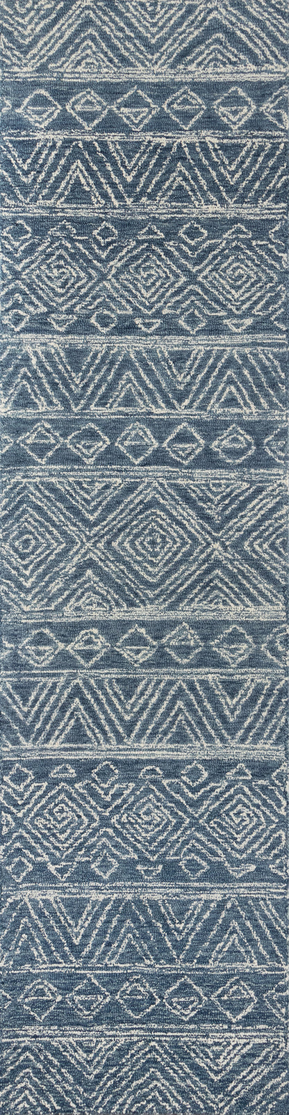 Blue woven rug, rectangular, with white geometric diamonds and chevrons in repeating horizontal bands.