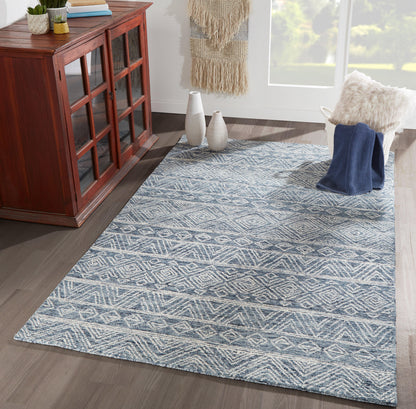 Rectangular blue-and-white geometric rug (4' x 6') with diamond motif on dark wood floor, modern living room scene.