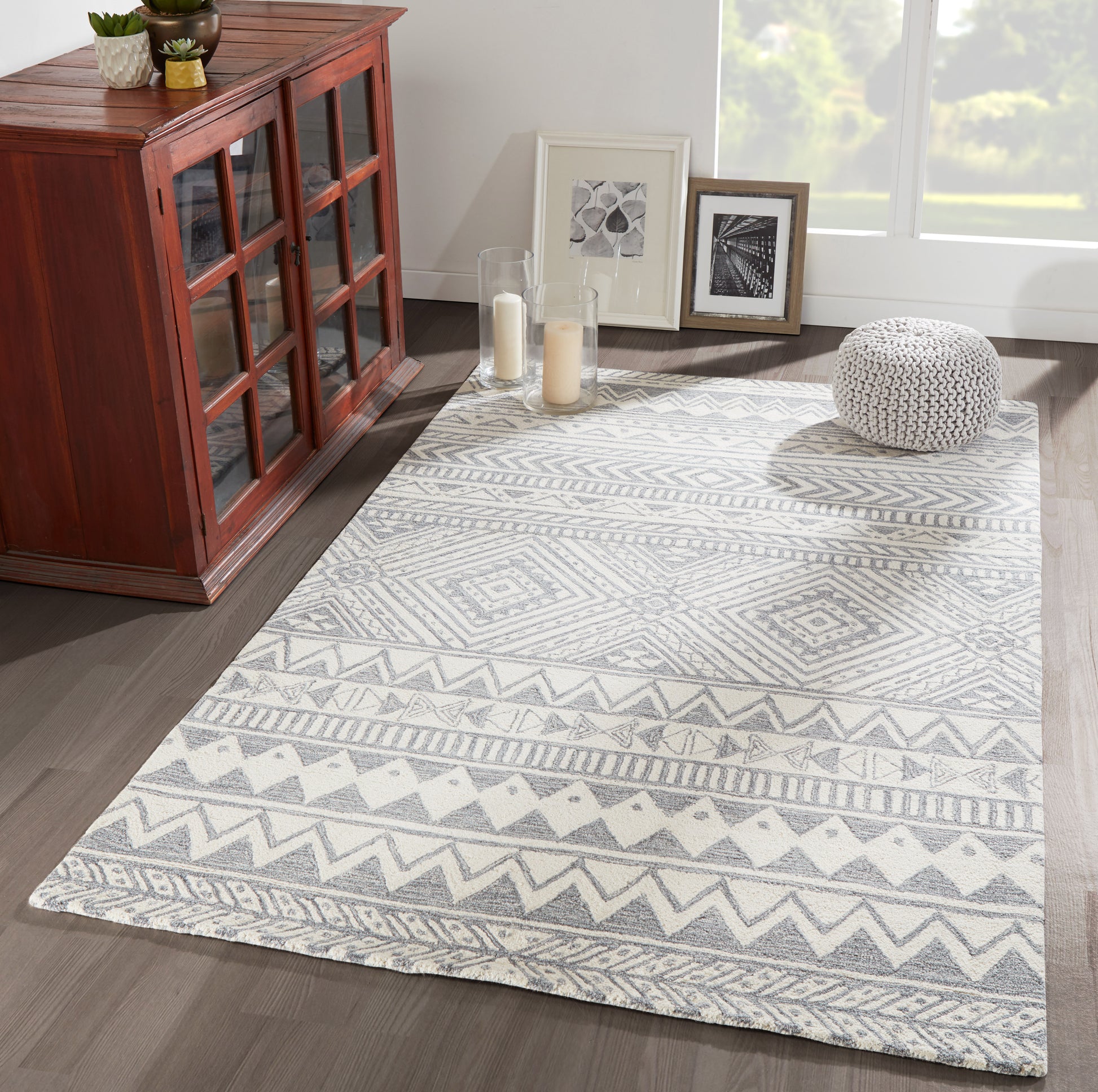 Gray & white geometric patterned rectangular area rug; modern living room decor, soft low-pile.