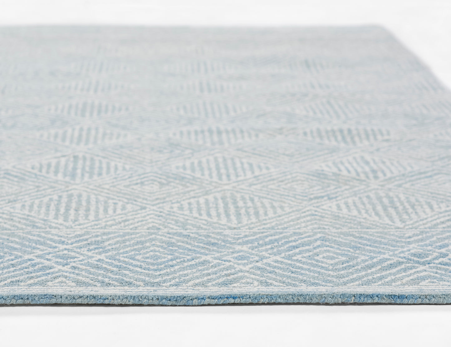 Blue and white geometric flat-weave rug with diamond/chevron pattern; rectangular, modern home decor.