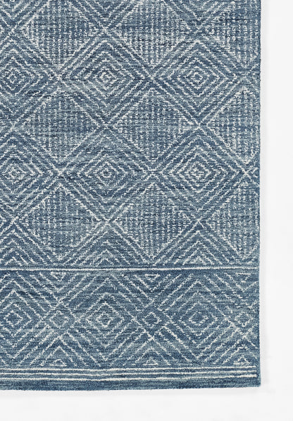 Blue textured rug with white geometric diamond lattice pattern and a light border.