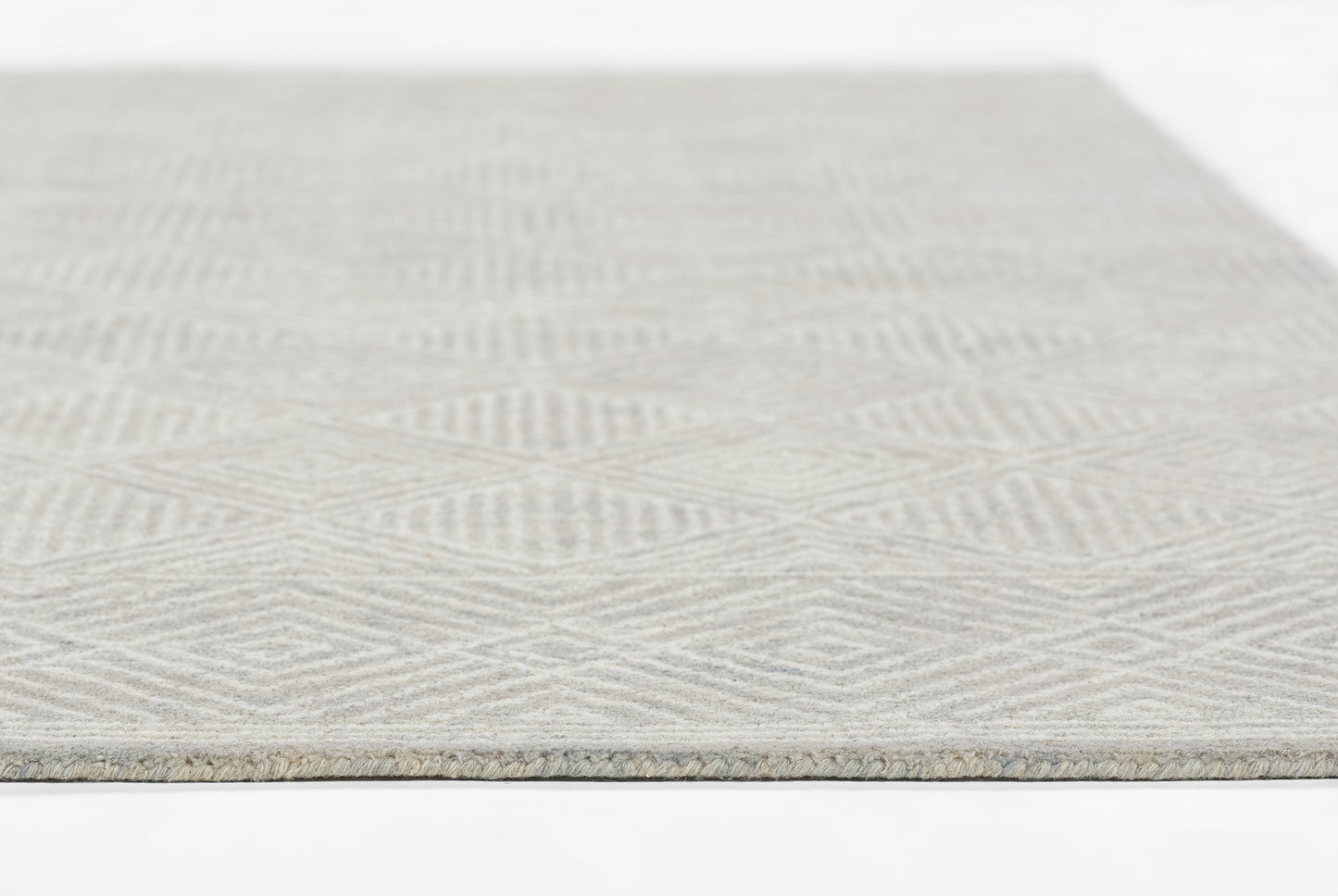 Gray low-pile woven rug with a subtle chevron/herringbone geometric pattern; rectangular rug for living room or entryway.