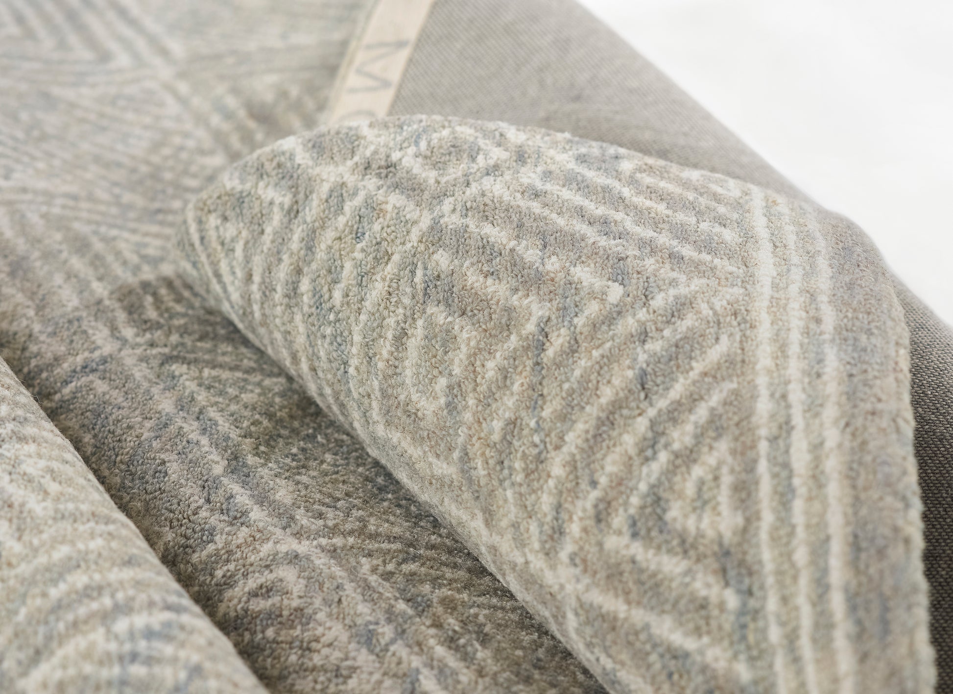 Gray, geometric-patterned woven runner with soft, textured fabric, folded for display.