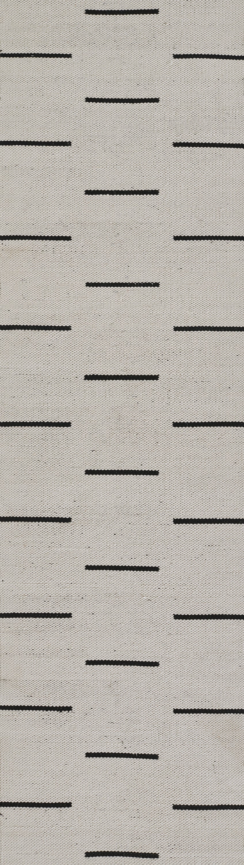 Beige textured rug with a repeating pattern of short black horizontal dashes in a geometric grid.