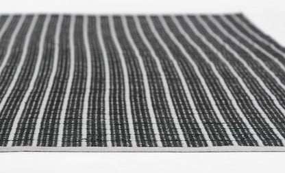 Woven black-and-white striped rug runner with textured weave.