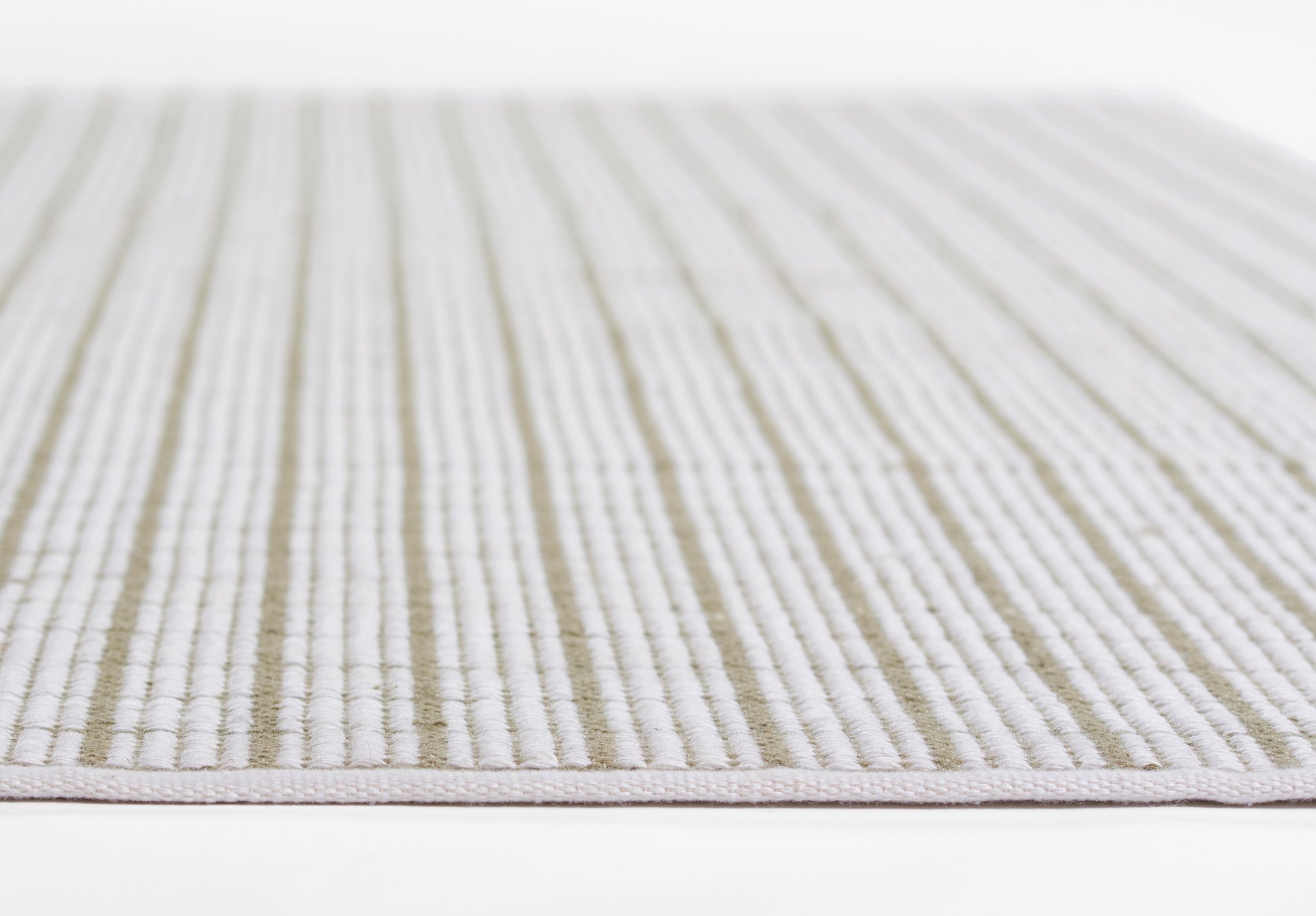 Low-pile striped rug in cream and muted green with light gray accents.