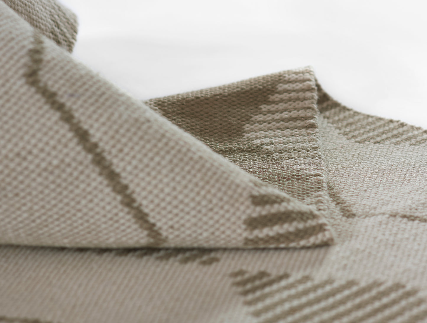 Beige woven rug runner with taupe diagonal stripes; soft textured surface.