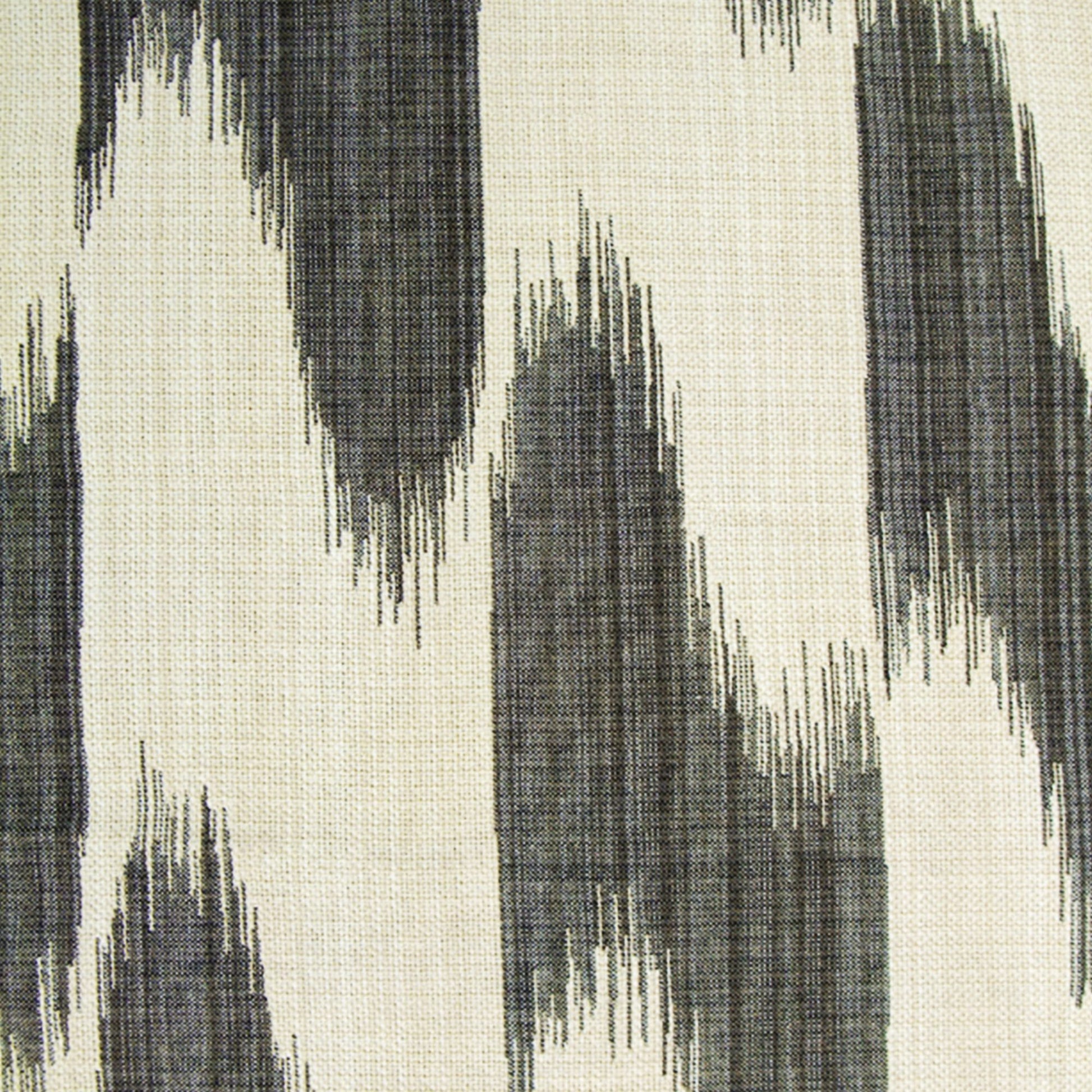 Beige fabric with abstract charcoal gray zigzag brushstroke pattern; ikat-inspired textile for upholstery or rug.