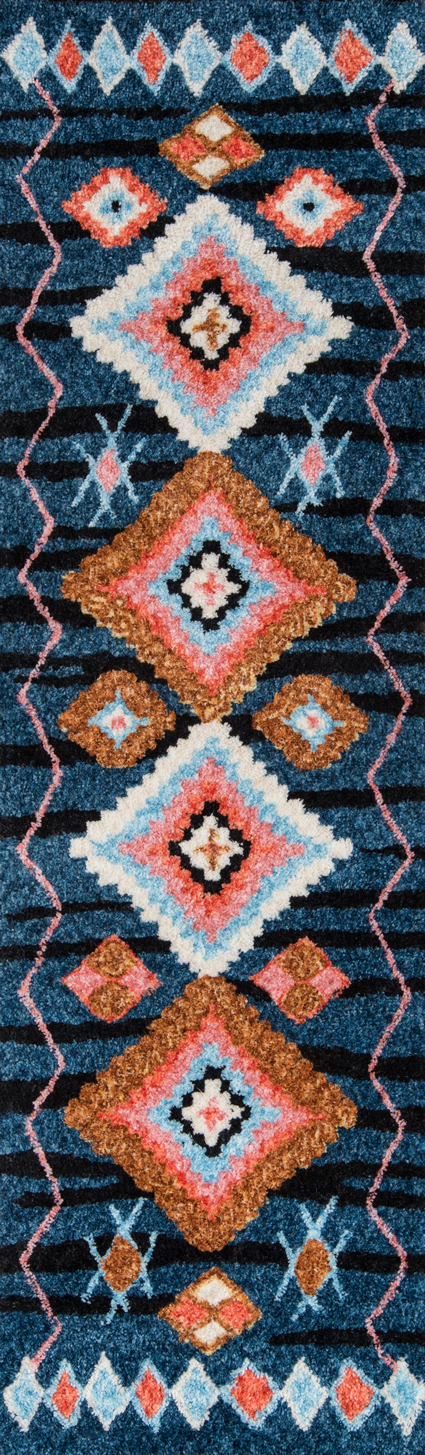 Boho geometric rug with diamond motifs in teal, coral, ivory, pink and gold on a navy blue background.