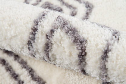 Cream shag rug with gray diamond stripe pattern, plush fluffy pile for cozy living spaces.