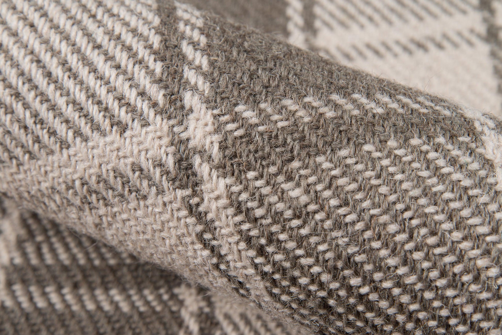 Close-up of a gray marled rug with beige threads and a textured pile; 2' x 3'.