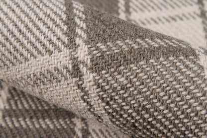 Close-up of a heather gray and cream woven rug with a chunky texture.