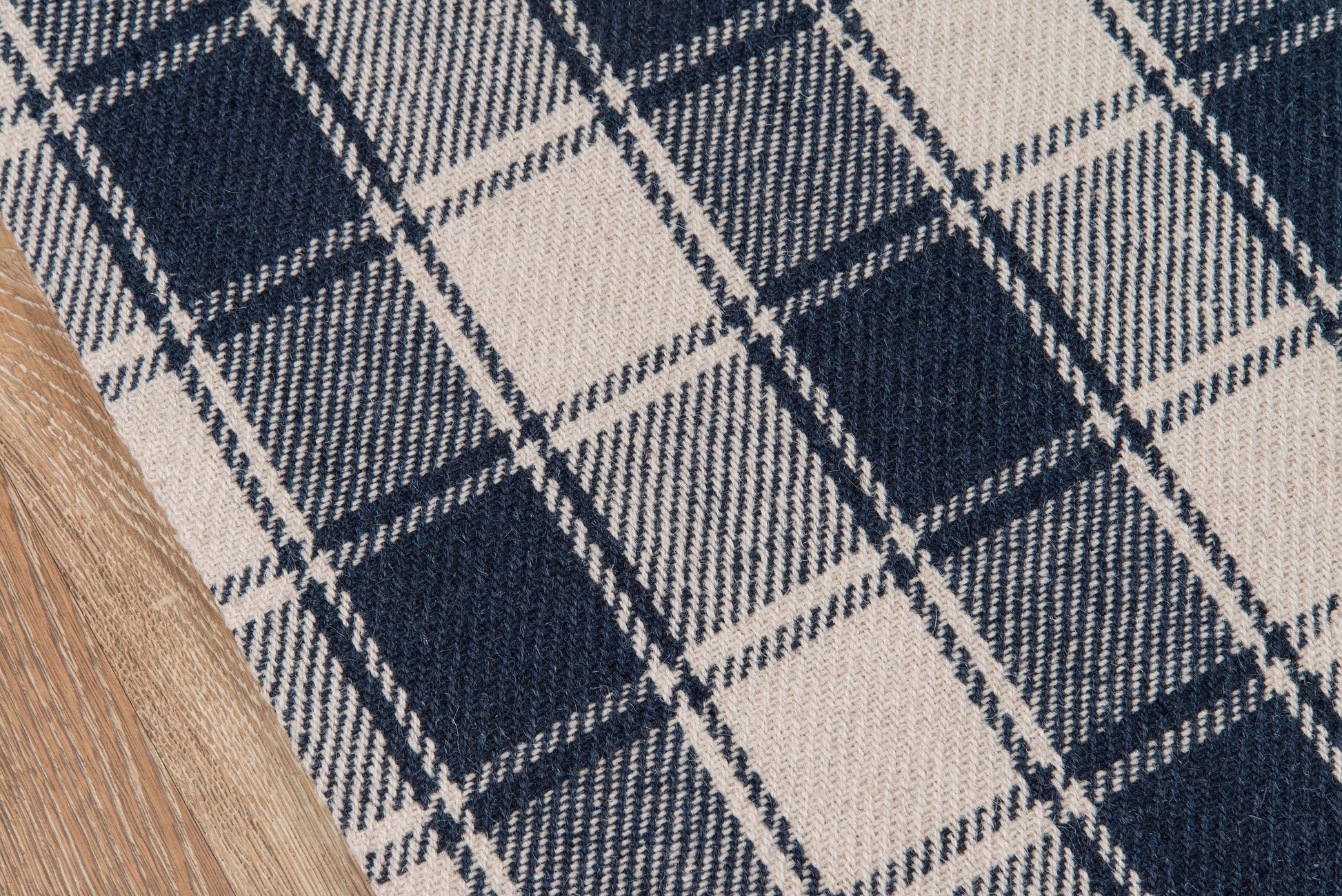 Navy & ivory plaid runner rug with a chunky weave, 2'3" x 8', shown beside a curved wooden accent.