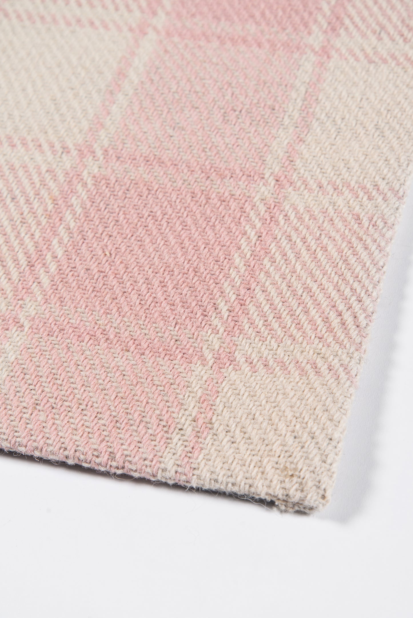 Soft pink and cream plaid woven wool-blend rug runner for cozy spaces.