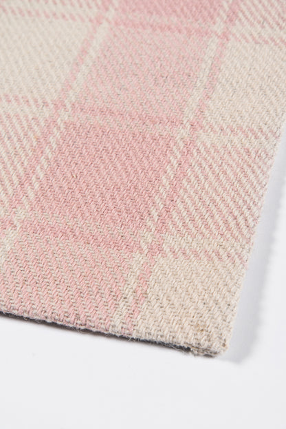Soft pink and cream plaid rug with a close-up woven texture and corner edge, 4' x 6'.