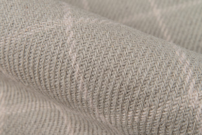 Close-up of soft gray-beige knitted fabric with visible ribbed texture.