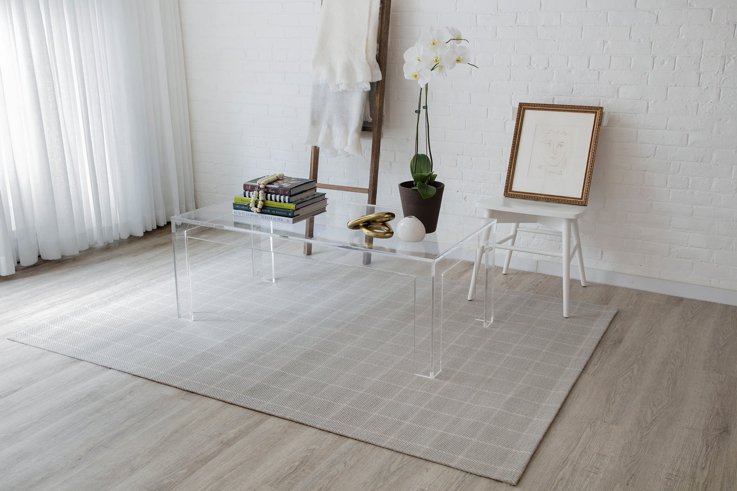 Gray geometric rug, 8' x 10', in a modern minimalist living room.
