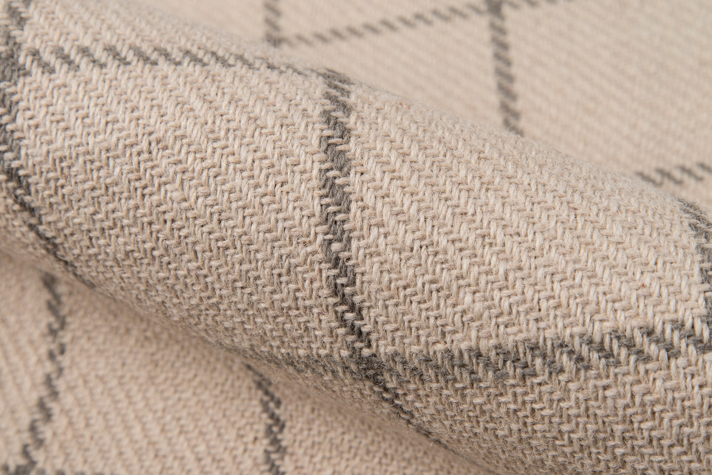 Beige woven wool blanket with gray plaid lines, textured fabric close-up.