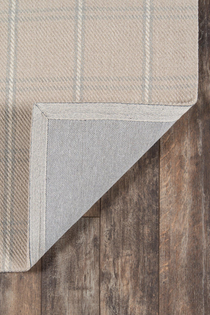 Beige plaid runner rug with light gray stripes, folded corner shows the woven underside on a dark wood floor.