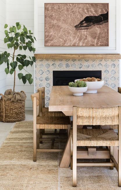 Large natural-toned area rug laid on an indoor floor, featuring a woven texture.