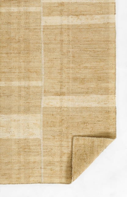 Beige woven mat with patchwork panels, natural fiber texture, flat weave, folded corner.