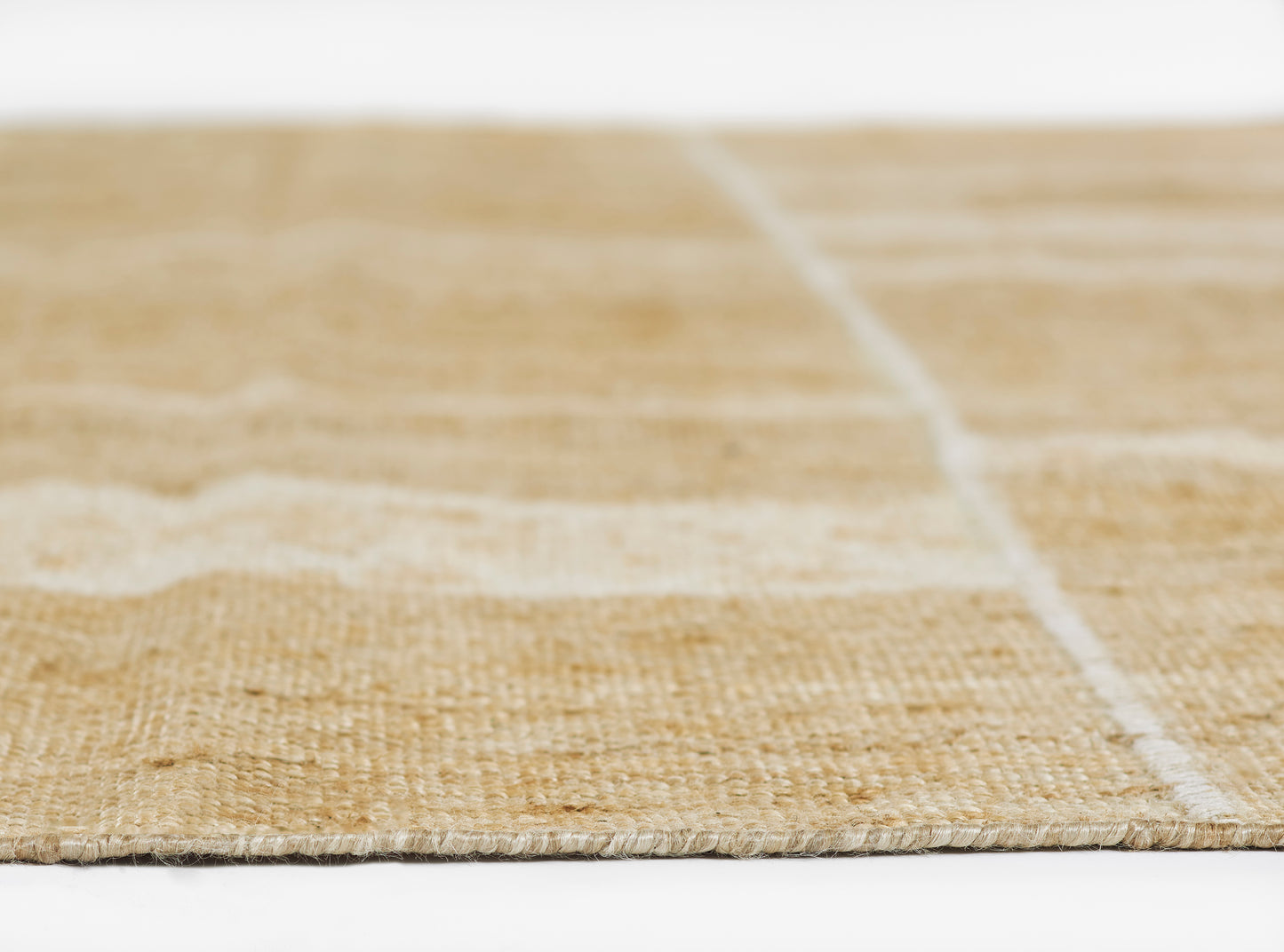 Natural beige jute rug with white stripe pattern, flat-weave, close-up view.
