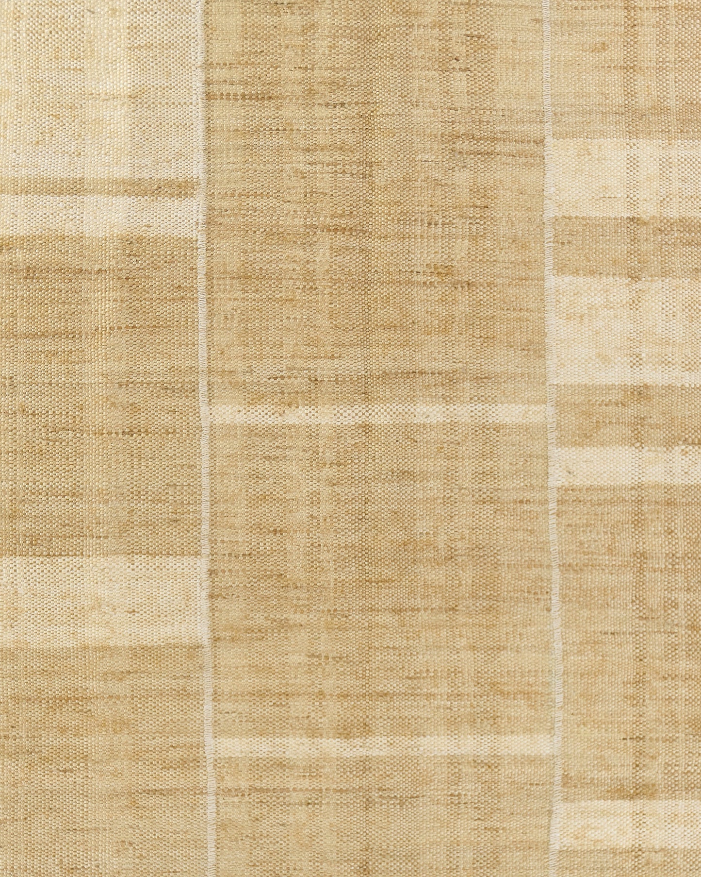 Beige natural woven mat with patchwork blocks; textured jute-like material, rectangular floor mat.