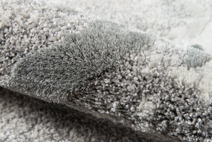 Close-up of a gray shag rug with dense plush pile & soft microfiber fibers.