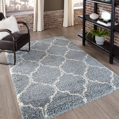 Blue-gray shag rug with white lattice pattern, rectangular and fluffy, in a modern living room.