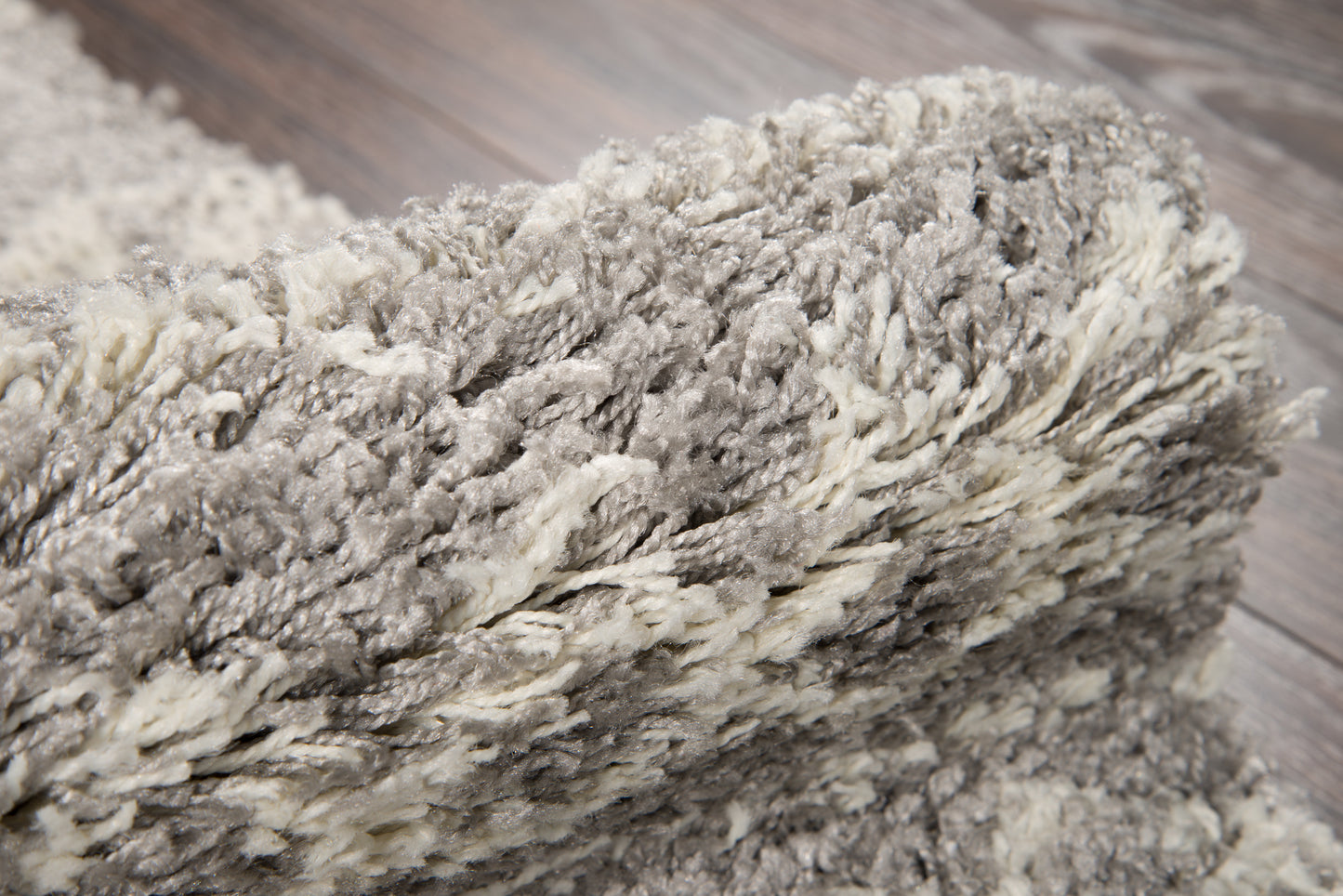 Gray & ivory shag rug with dense high-pile, soft fluffy fibers for cozy modern decor.