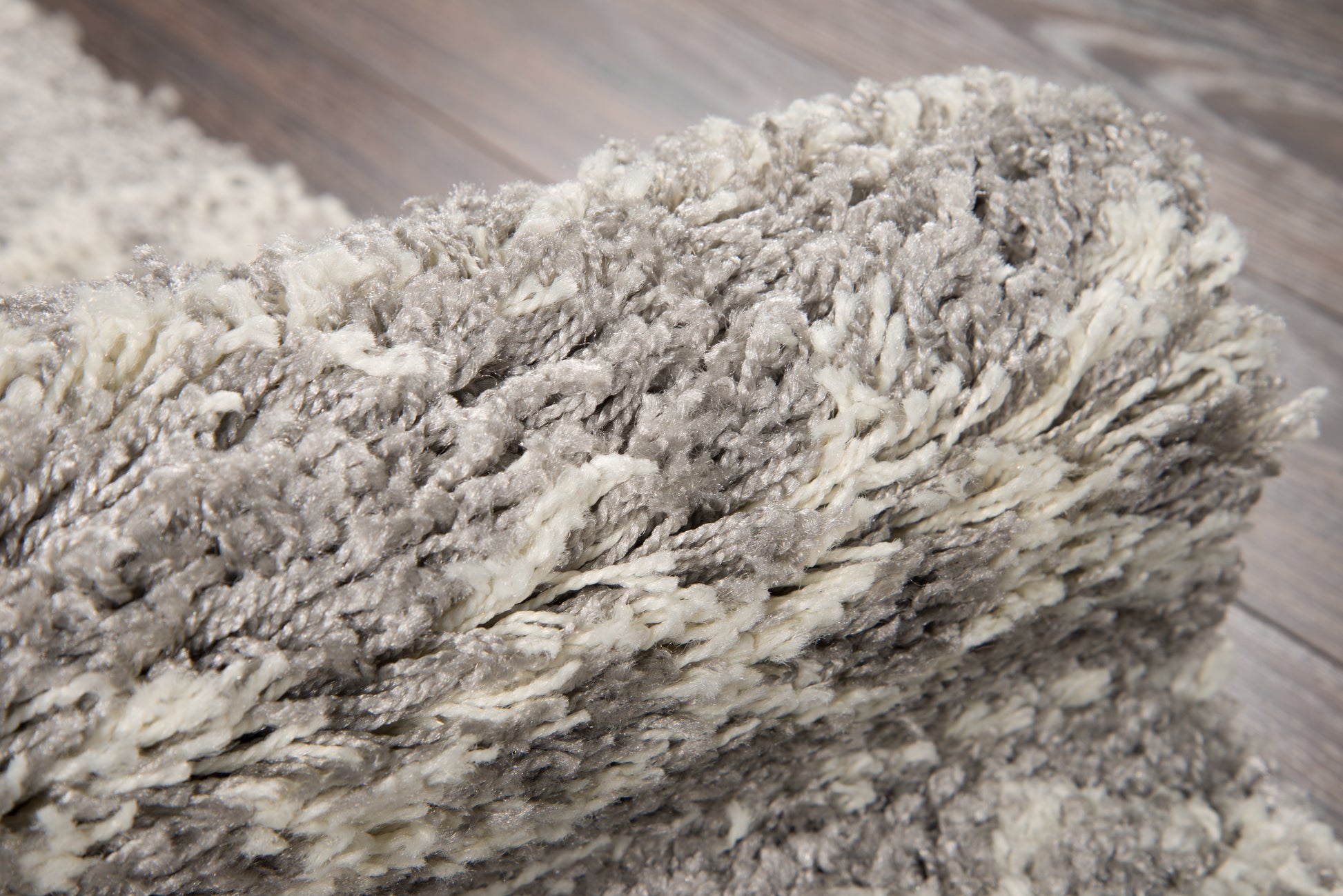 Gray & ivory shag rug with dense high-pile, soft fluffy fibers for cozy modern decor.