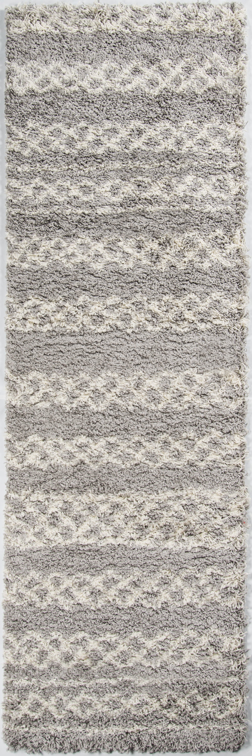 Rectangular gray shag rug with cream wavy stripes; plush high-pile for a cozy modern floor.
