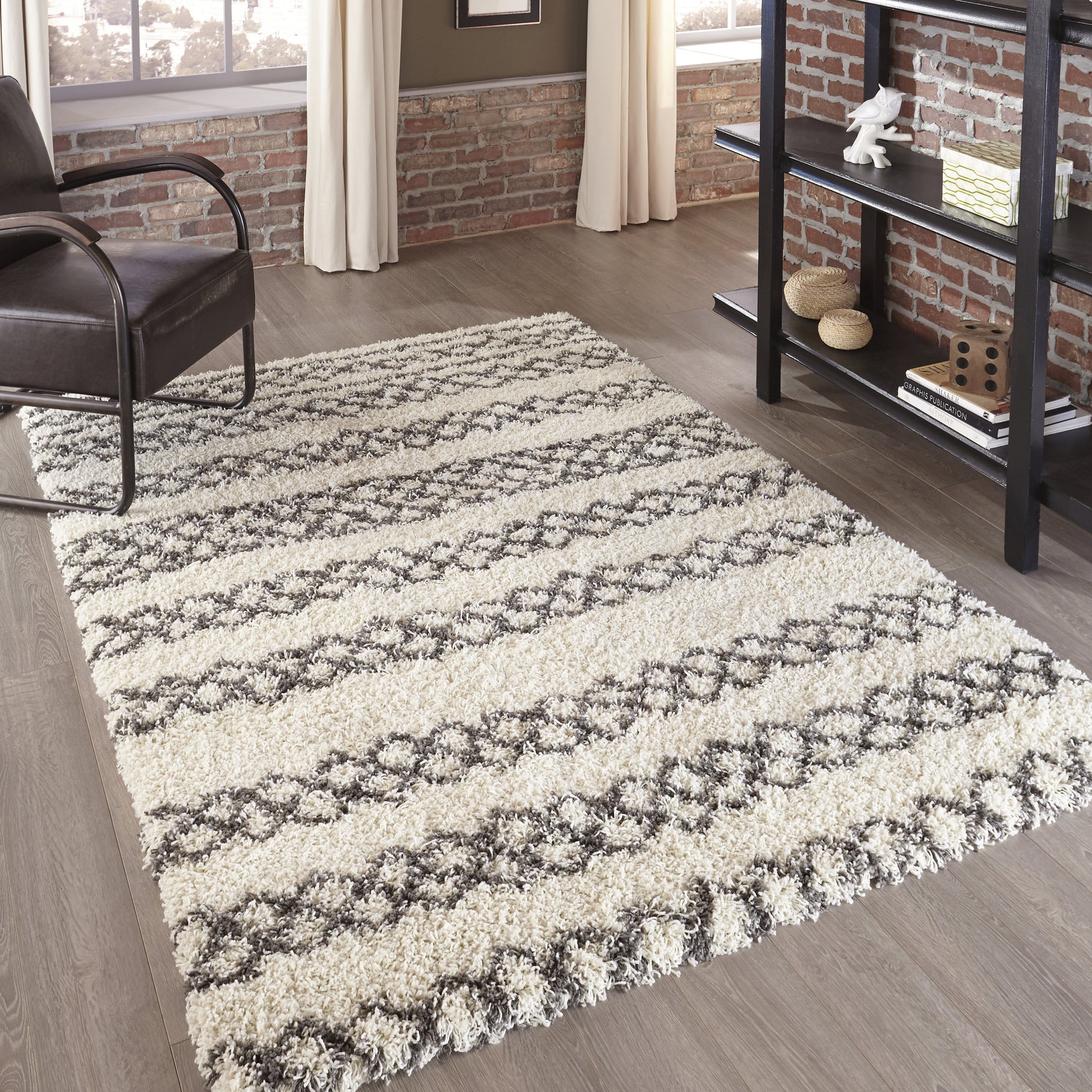 Ivory & gray shag runner rug with diamond stripe pattern on wood floor in a modern industrial living room.