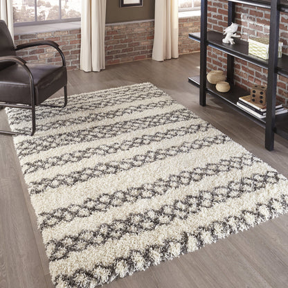 Ivory & gray shag runner rug with diamond stripe pattern on wood floor in a modern industrial living room.