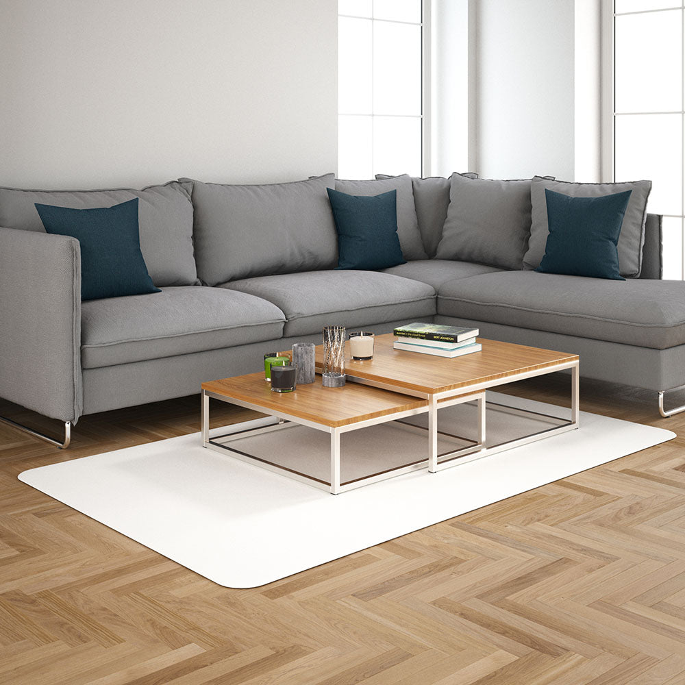 L-shaped light gray sectional sofa with teal pillows, two-tier wooden coffee table on a white rug in a bright living room.