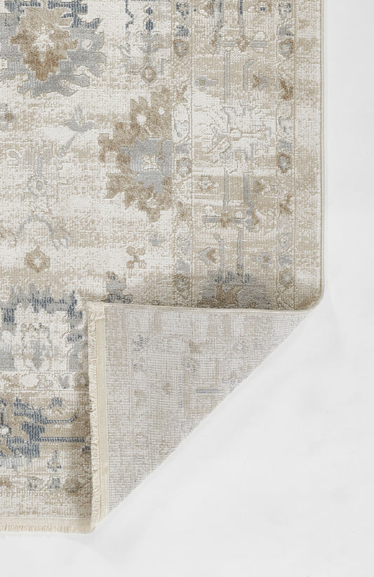 Rectangular distressed oriental rug in ivory & beige & blue-gray with floral medallion; folded corner shows underside.