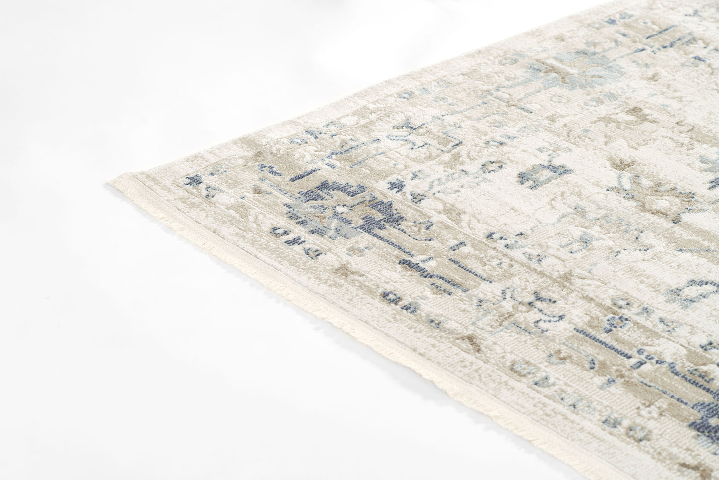 Beige distressed area rug with muted blue floral pattern & fringe edge; rectangular, cozy living room rug.