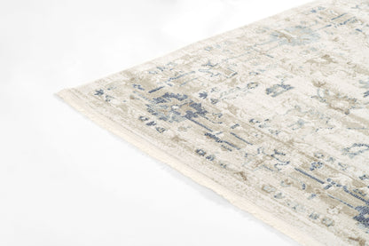 Beige distressed area rug with muted blue floral pattern & fringe edge; rectangular, cozy living room rug.