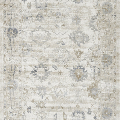 Rectangular distressed cream rug with pale blue-gray floral motifs and ornate border; vintage Persian-inspired.