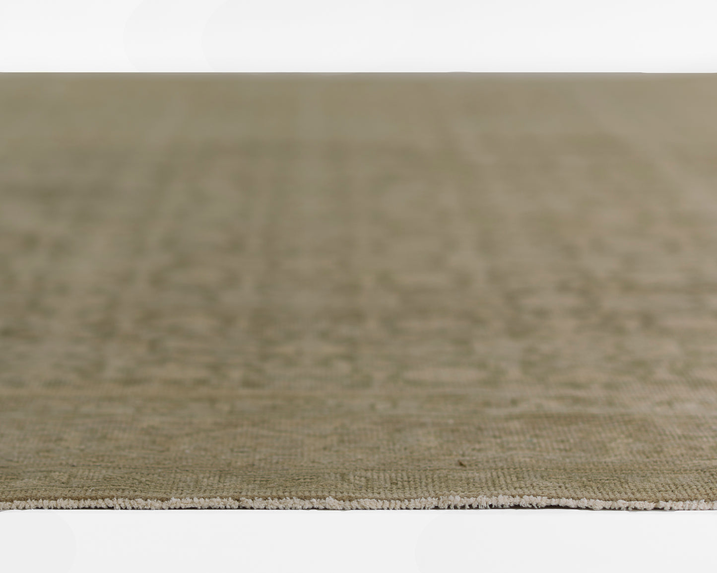 Olive green flatwoven rug with beige fringe, natural textured weave for living room floor.